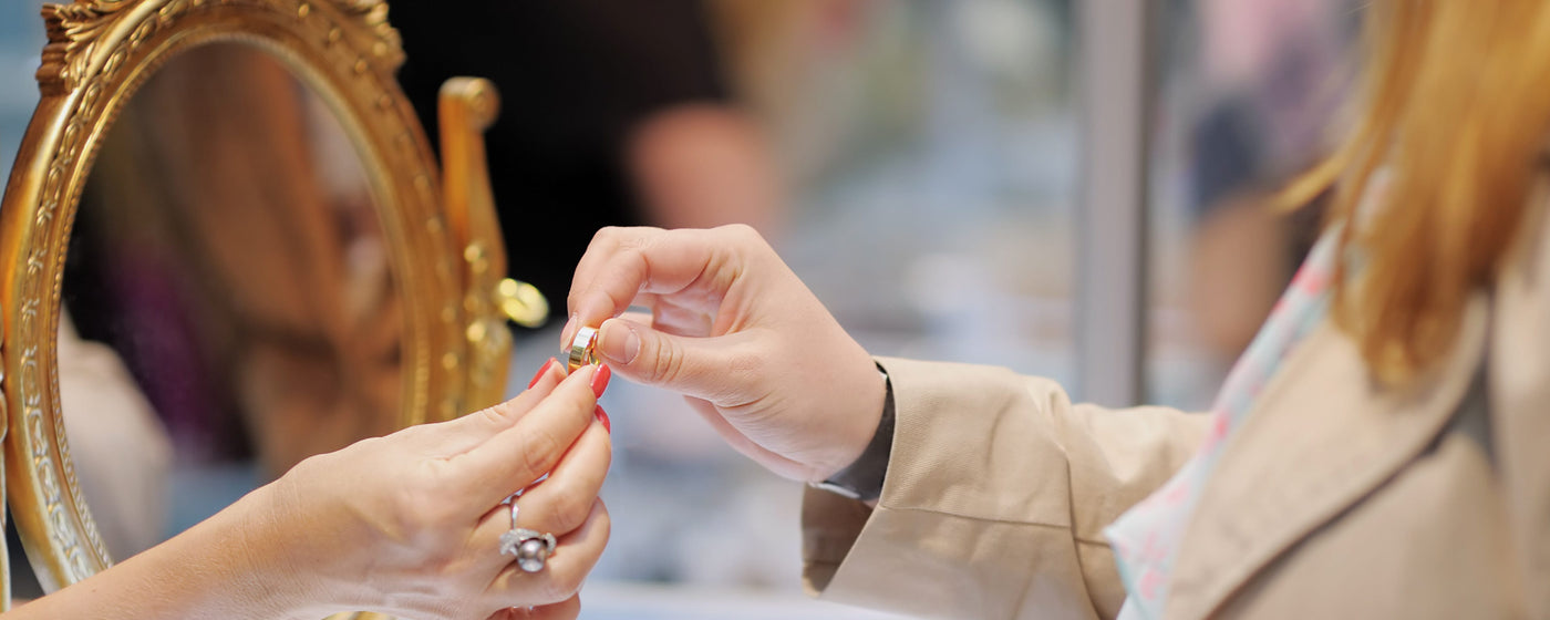 Customer holding a gold wedding band