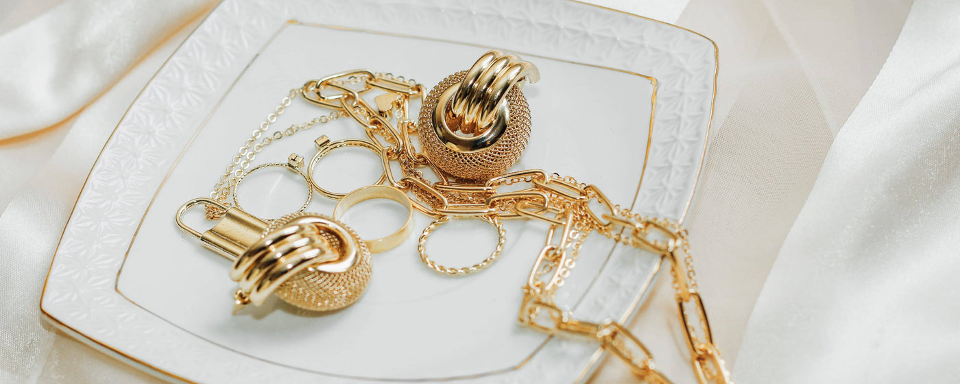 Gold accessories on jewelry dish